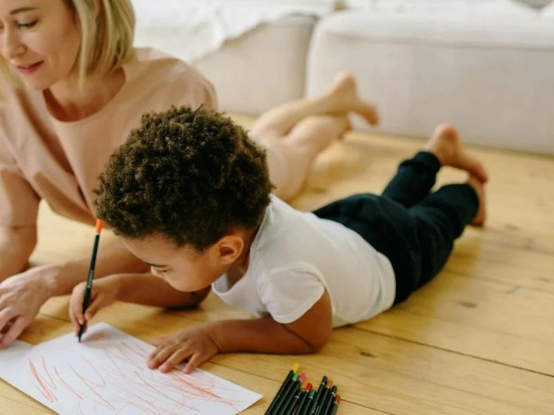 Children painting on hardwood flooring