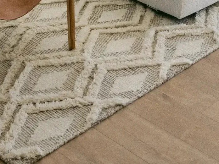 Blue area rug under modern dining room table